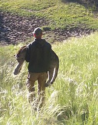 Eric York carrying lion as walking away.