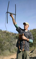 Eric York tracking lion with radiotelemetry.