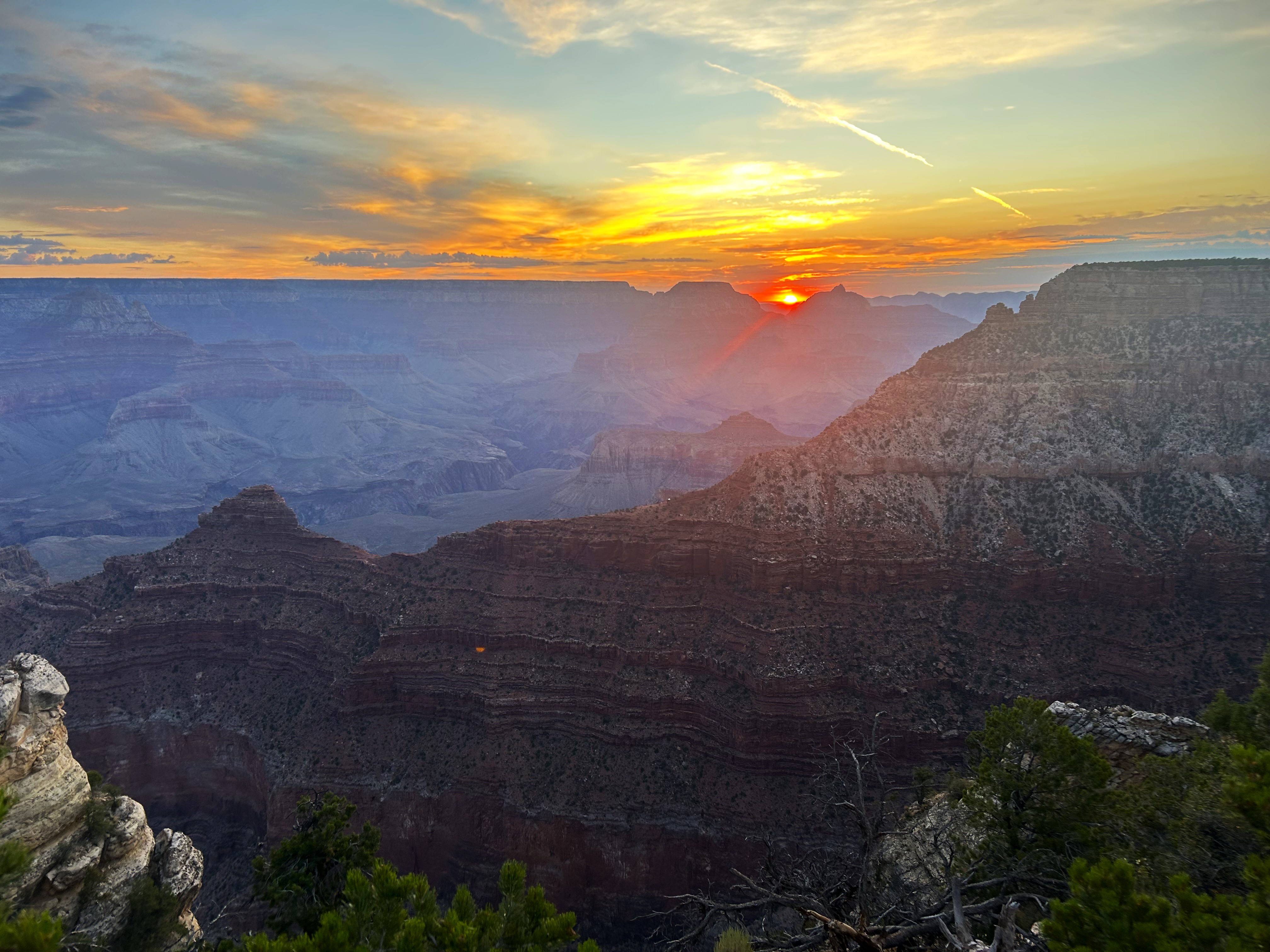 Sunrise 8-22-2025 A sunrise with an orange sun on a canyon landscape
