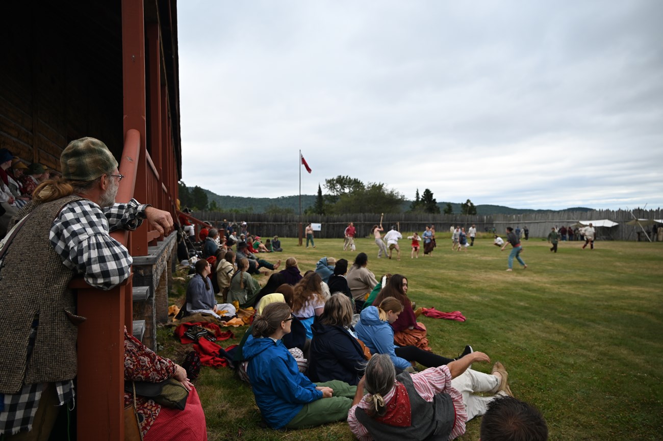 Rendezvous Days Lacrosse A crowd sitting on the Great Hall lawn watching a lacrosse game