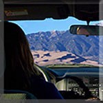 View through windshield to dunes and mountain