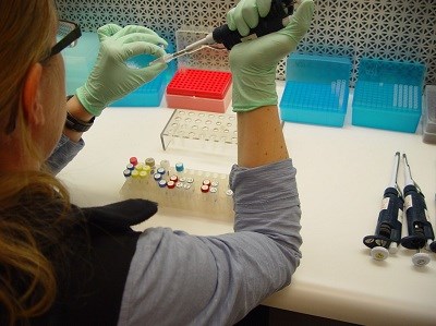 A girl running genetic tests with test tubes