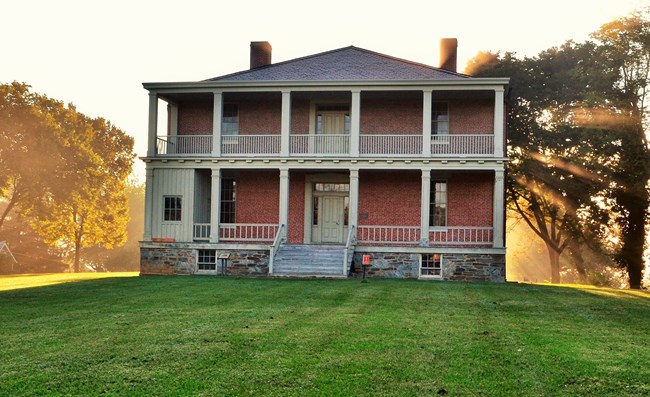 two story brick house with double porches