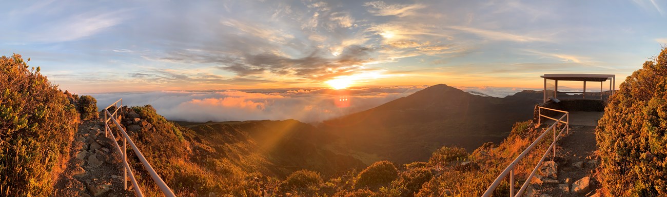 Panoramic image of an overlook illuminated by a rising sun.