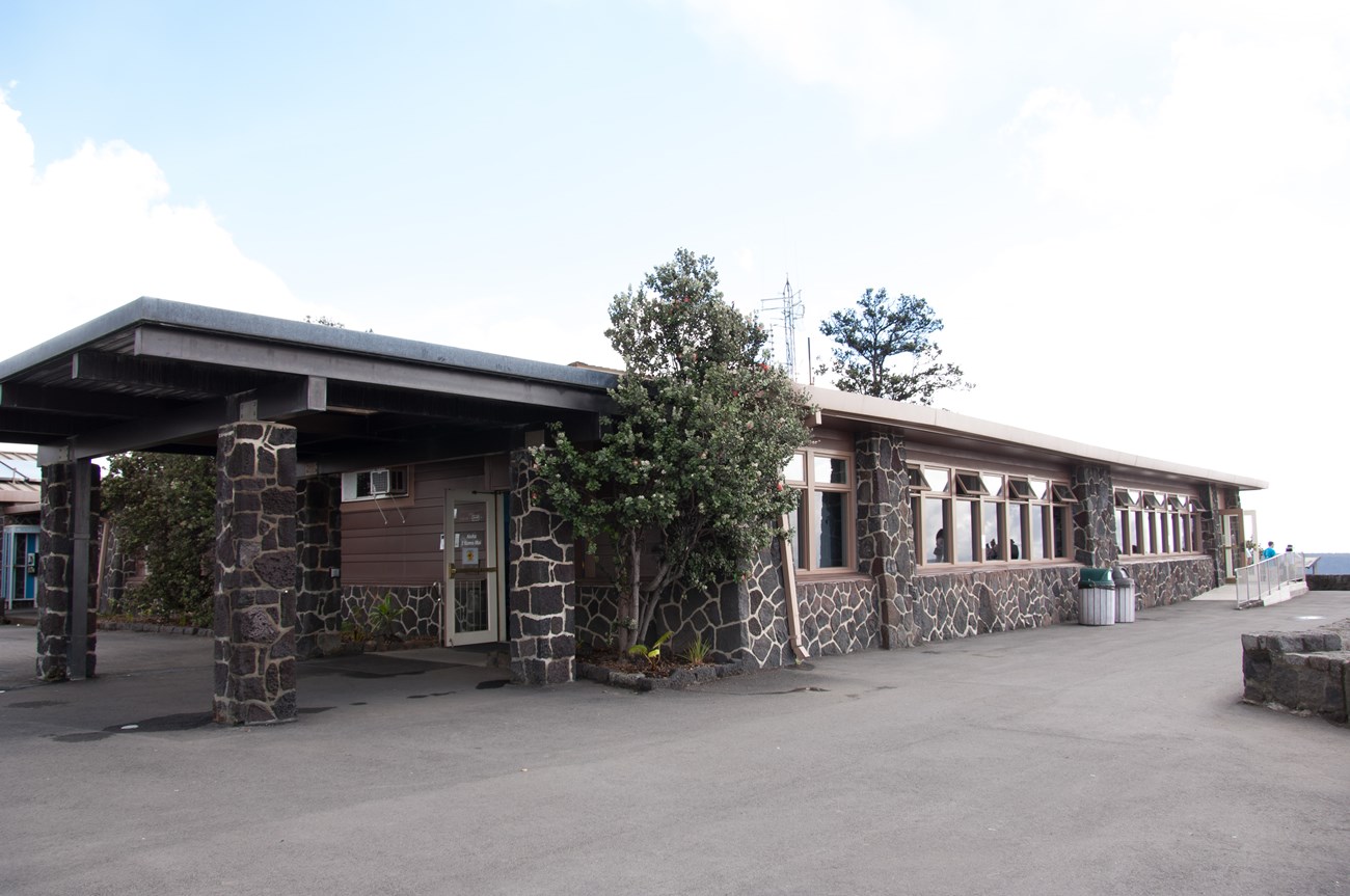 Single story rectangular building with lava rock facade.