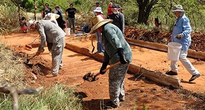 Archeological field school students clearing off a building foundation at Honouliuli