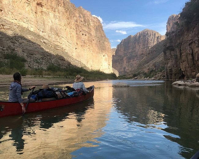 The Rio Grande River in Boquillas Canyon at Big Bend National Park Scientists in a canoe on the Rio Grande River in Boquillas Canyon at Big Bend National Park