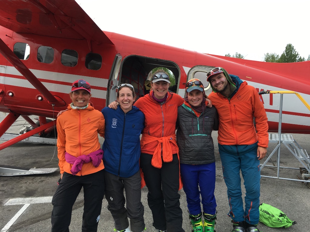 Five members of Denali 14K Patrol #5 pose outside their air taxi