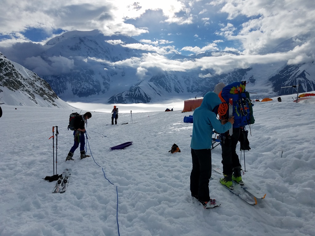 A climbing team does a final gear check before heading down glacier from Baescamp