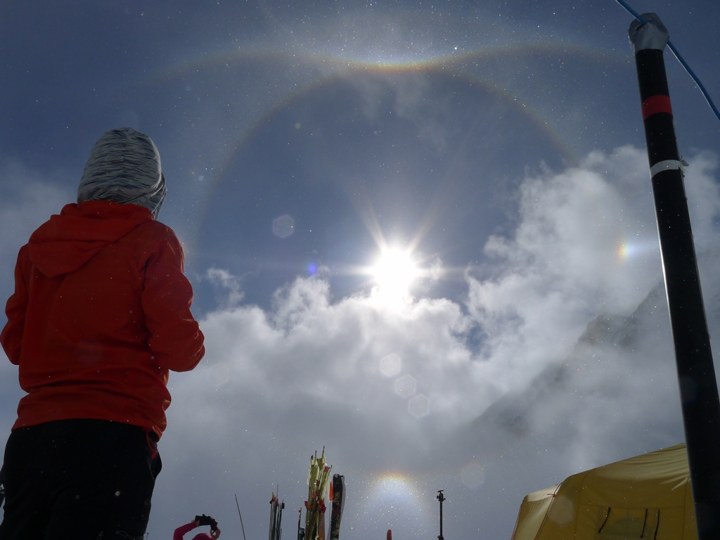 The interplay of sun and clouds creates three interlocking sundogs over 14 camp