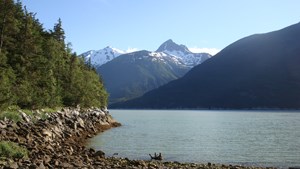 View of shoreline, mountains, and ocean.