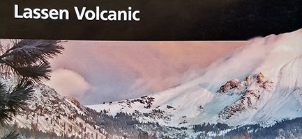 A picture of the cover of a brochure featuring a snow-covered mountain backed by pink sky