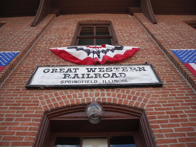 Doorway of brick Lincoln Train depot building with sign