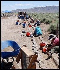 Group of archaeological volunteers digging in the dirt