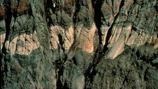 A close-up view of the yellow rock bands on the wall of Sunset amphitheater.