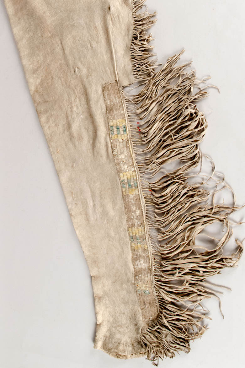 Pair of men's leggings made from cured unsmoked deerskin with porcupine quill decorated side panels and fringe decorations.