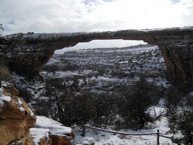 Owachomo natural bridge with snow falling