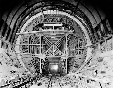 Metal beams and tools inside a circular stone tunnel