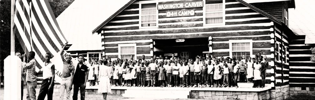 campers in front of a lodge