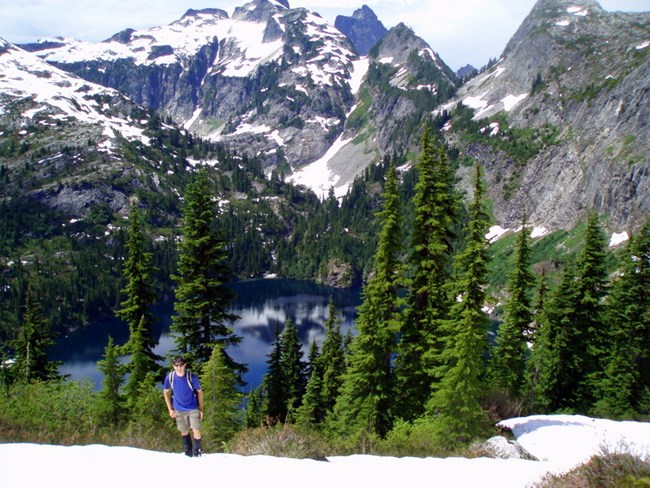 Hiker on ridge above Thornton Lake