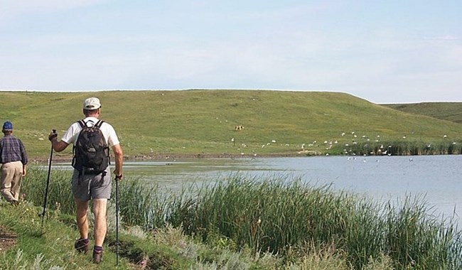 A Hiker along the shore of a lake