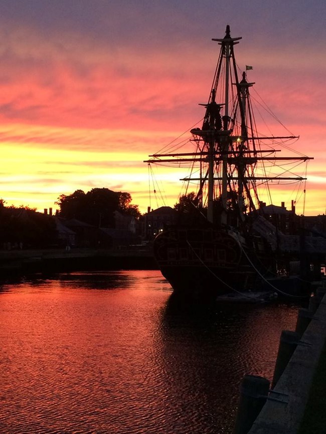 Photograph of San Salvador replica. Photo shows the ship with 2 main masts sailing in San Diego Bay. Point Loma is in the background.