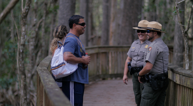 rangers_public Two law enforcement rangers having a conversation with two park visitors.