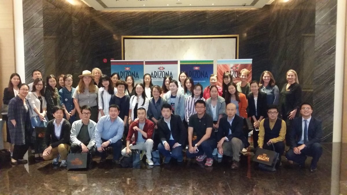 Hart in Shanghai A group of 40 people standing in front of banners that say Arizona.