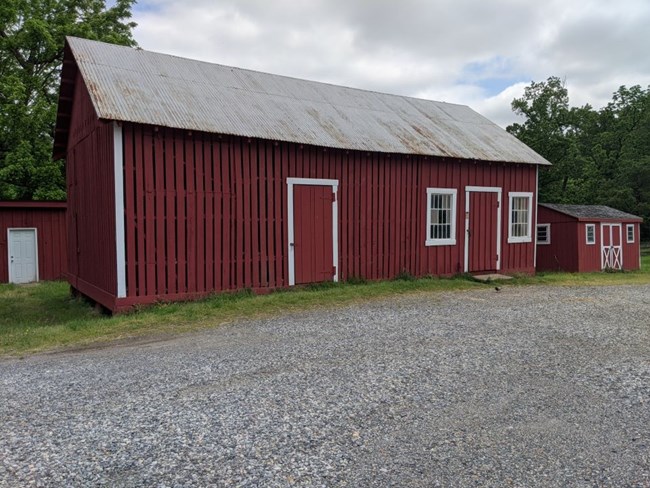 Red wooden building used to store animal feed