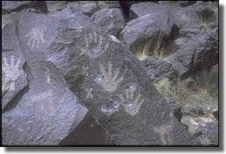 Petroglyphs of human handprints in Piedras Marcadas Canyon. Unfortunately, the palm areas of these images were hollowed out by gun shot damage.