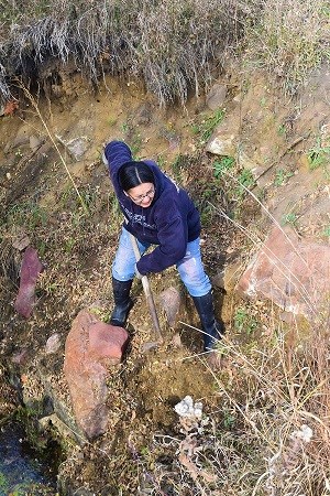 A woman shoveling in a quarry