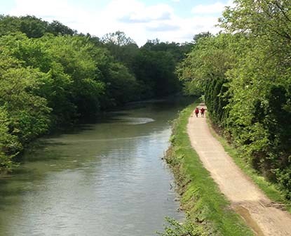 Visitors walking along the canal towpath next to the Potomac River.