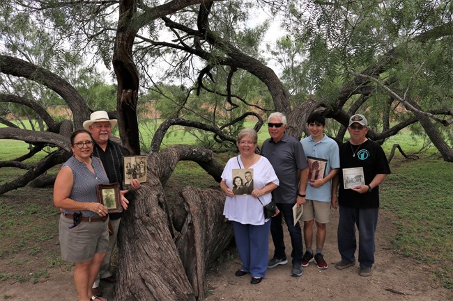 Family standing under a tree