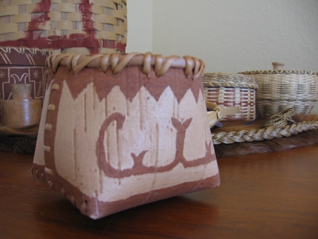 A picture of woven sweetgrass baskets set on a table.