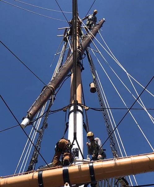 Riggers volunteer working aloft on BALCLUTHA with NPS volunteer riggers supervisor.