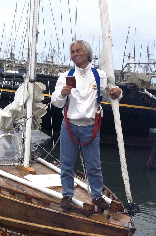 an 83-year old Horie stands on the deck of a sailboat
