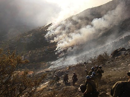 Crew members working in a recently burned area