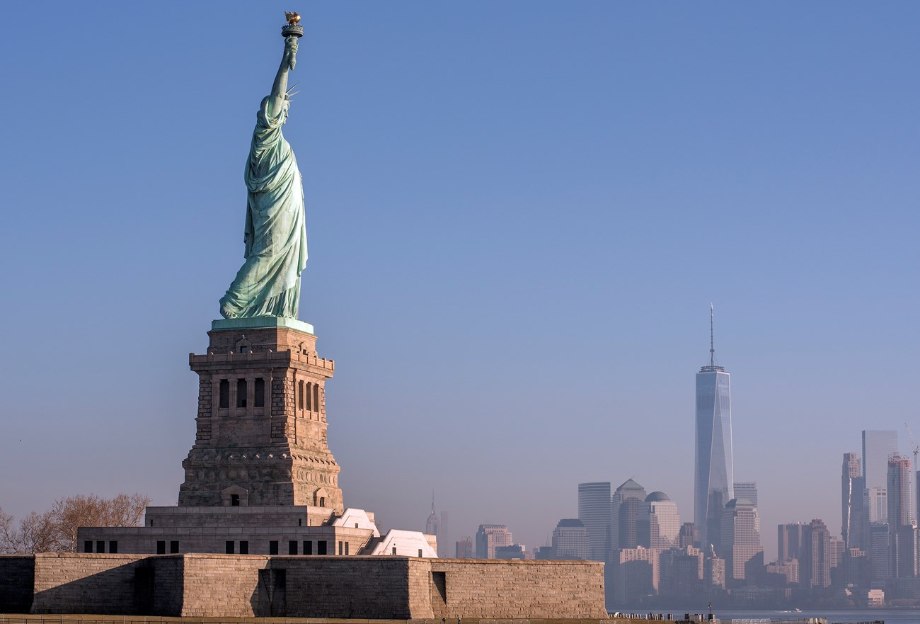 Statue of Liberty photo taken froma boat with the NYC skyline in the background