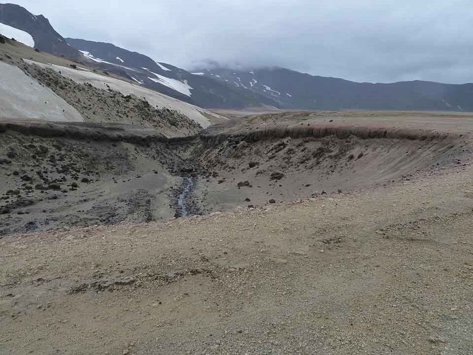 A phreatic explosion crater near a lava flow