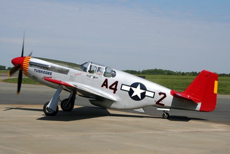 A silver plane with a red tail and elevator