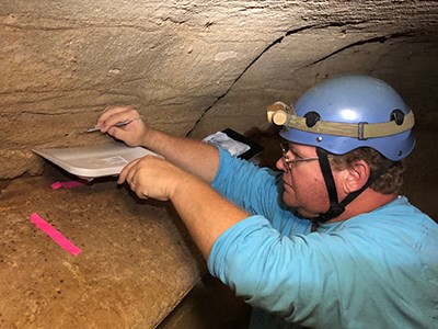 person working in a cave