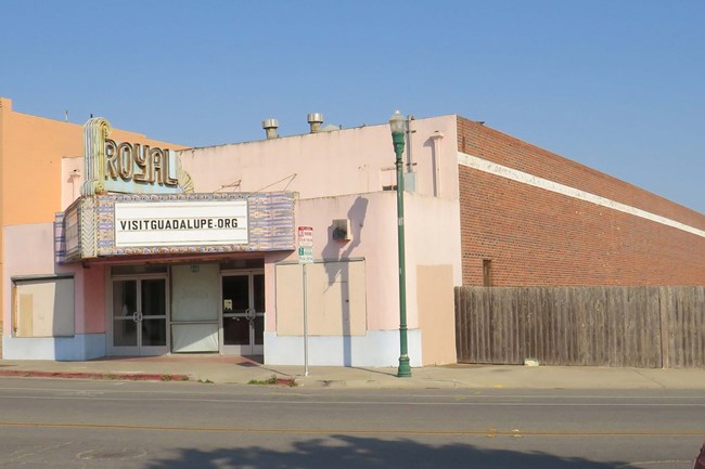 A building with a large sign and double entrances.