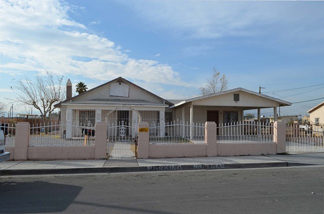 One and a half story bungalow topped with a medium-pitch frotn gable roof and stucco walls