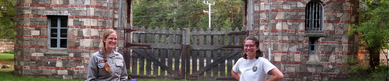 Two women standing in front of bat mist netting at Brown Mountain Gatehouse