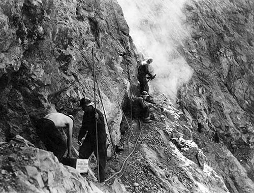 Civilian Conservation Corps enrollees construct a portion of the River Trail along a ledge around 1935.