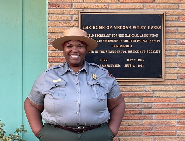 Keena Graham posing in front of the Medgar and Myrlie Evers Home National Monument