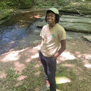 Intern standing by stream