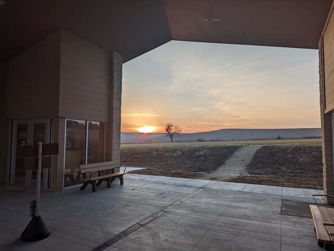 Visitor Center Breezeway with benches at sunset.