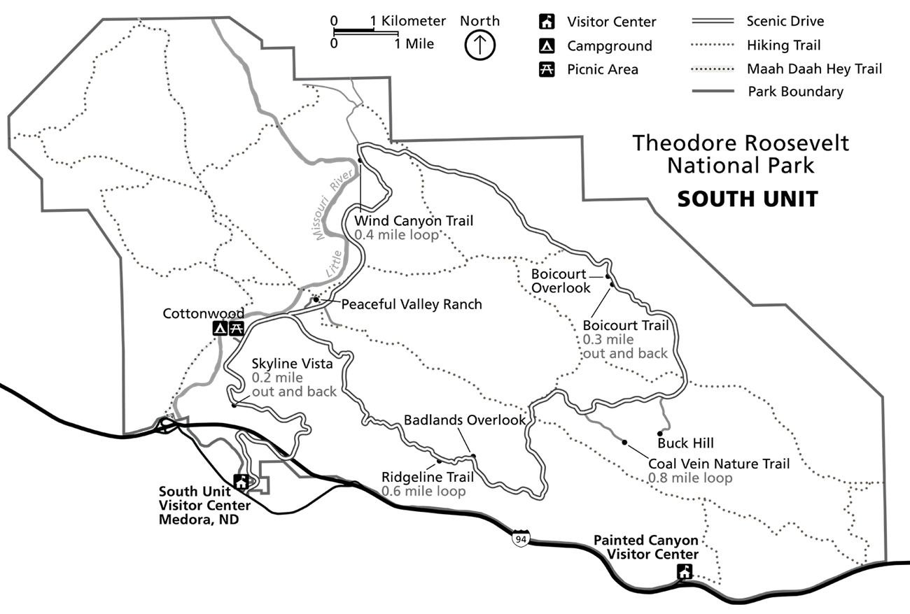 A line drawing map showing the South Unit's boundary, a scenic loop drive, and numerous trails and overlooks