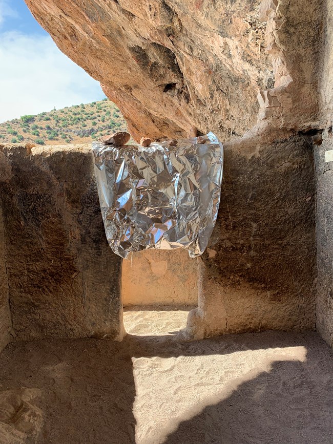 cliff dwelling door wrapped to prepare for wildfire